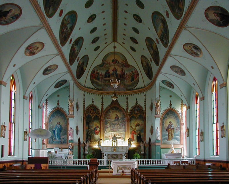 The nave of St. Ignatius Mission, its vaulted ceiling and walls covered in painted murals