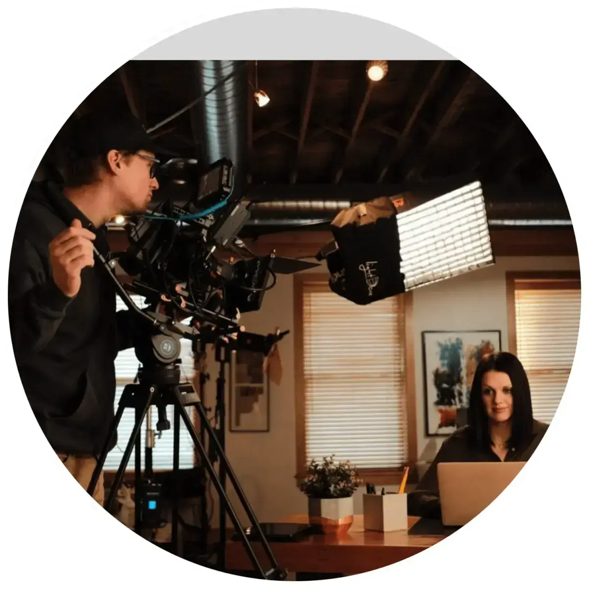 video-production-interview-setup-videographer-lighting-woman-at-desk video-production-interview-setup-videographer-lighting-woman-at-desk
